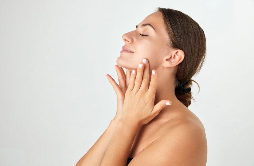 Woman with glowing skin enjoying facial skin treatment