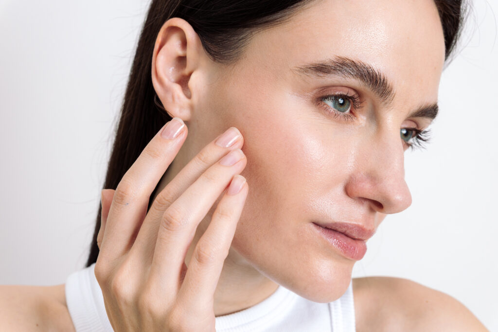 Woman with clear glowing skin following professional skincare treatment